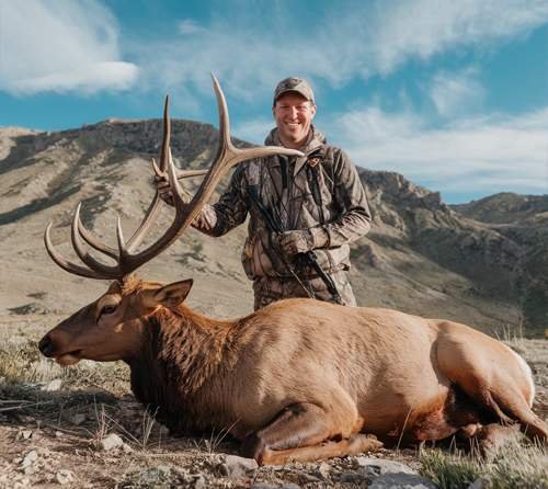 Stephen posing with an Elk after successful hunt